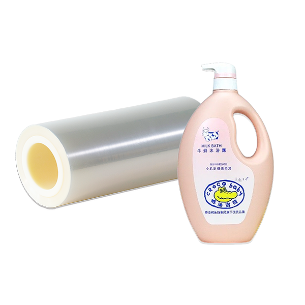 Various bottles of cleaning products, including laundry detergent and surface cleaners, alongside rolls of white PE label film.